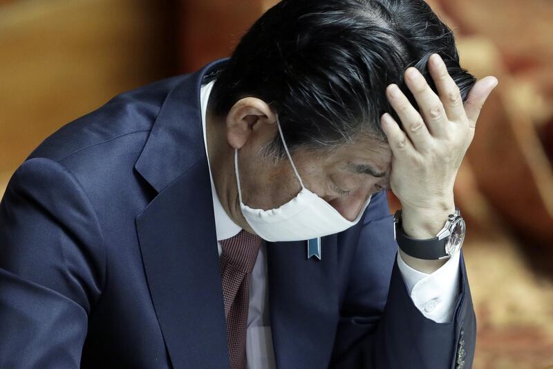 Shinzo Abe, Japan's prime minister, wears a protective mask during a plenary session at the upper house of parliament in Tokyo. Bloomberg