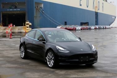 A Tesla Model 3 car leaves a cargo vessel at a port in Shanghai. The American carmaker had expected to start China deliveries in March. REUTERS/Stringer.