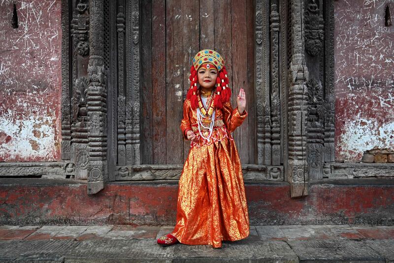 A girl dressed as the living goddess Kumari prepares for traditional rituals in Kathmandu, Nepal. AFP
