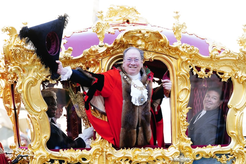 Michael Mainelli, the 695th Lord Mayor of the City of London, waves from the State Coach during the Lord Mayor's Show in the City of London. PA