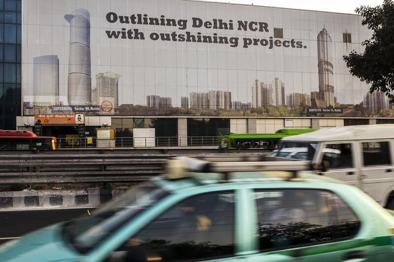 Traffic passes a billboard picturing in the Delhi National Capital Region. Prashanth Vishwanathan/Bloomberg