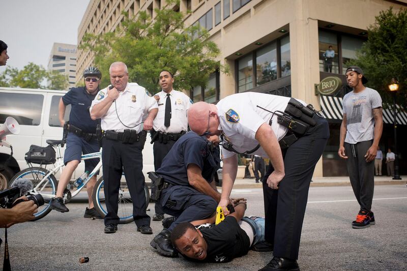 BALTIMORE, MD- SEPTEMBER 02:
Kwame Rose is arrested after he and several other protesters blocked various intersections in downtown Baltimore.
The first hearing for six Baltimore police officers charged in the death  Freddie Gray in Baltimore, Maryland on September 02, 2015.
(Photo by Marvin Joseph/The Washington Post via Getty Images)