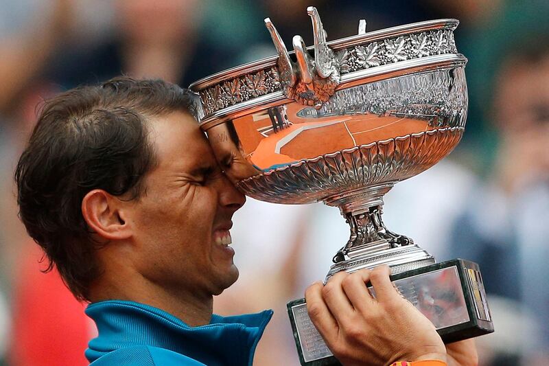 FILE - In this June 10, 2018, file photo, Spain's Rafael Nadal reacts while holding the trophy after defeating Austria's Dominic Thiem in the men's final match of the French Open tennis tournament in Paris. Nadal, a French Open champion yet again a week past his 32nd birthday seems to stay forever young. (AP Photo/Thibault Camus, File)