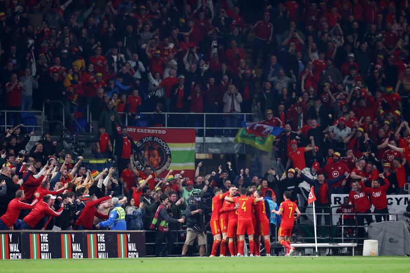 Gareth Bale celebrates with teammates in front of the Wales fans after scoring the second goal. Getty