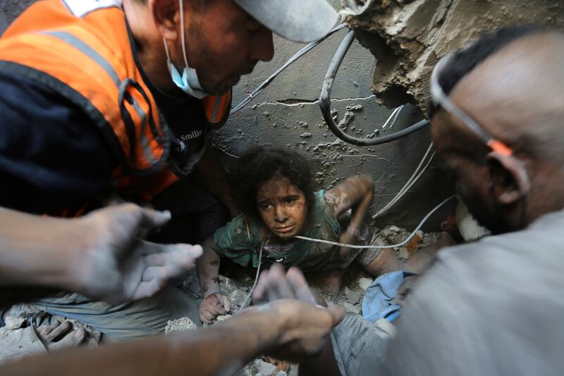 A girl is rescued from the rubble of a building destroyed by Israeli air strikes in Jabalia refugee camp, in the northern Gaza Strip. AP Photo