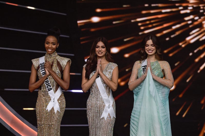 The final three Miss Universe contestants, left to right, Miss South Africa, Lalela Mswane; Miss India, Harnaaz Sandhu; and Miss Paraguay, Nadia Ferreira, pose on stage during the pageant. AFP