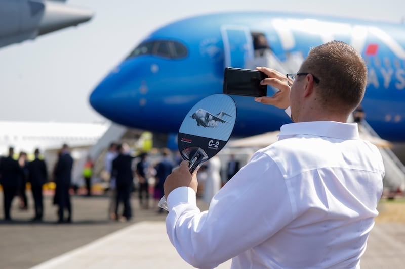 An aviation fan uses a fan to keep cool amid soaring temperatures. Bloomberg