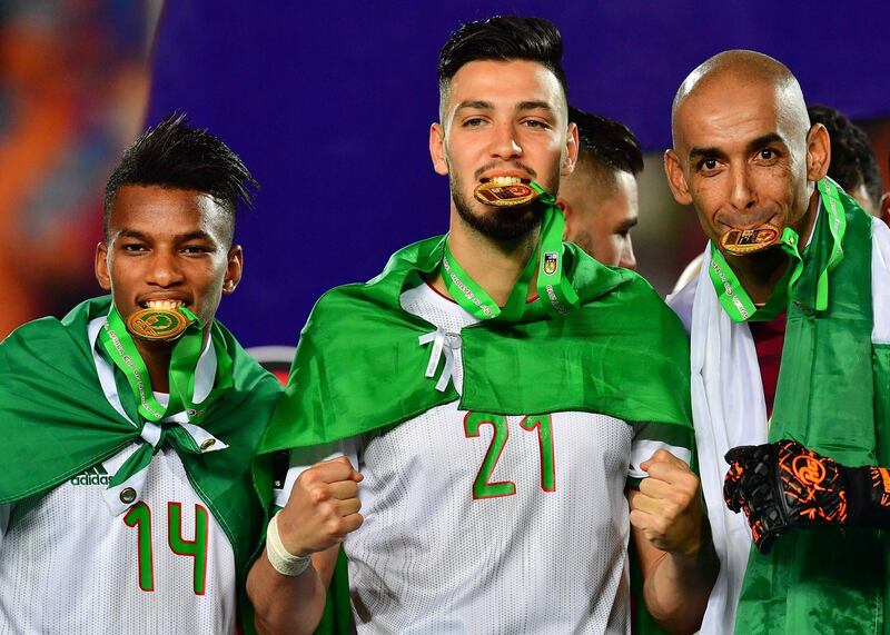 Hicham Boudaoui, Ramy Bensebaini and goalkeeper Azzedine Doukha celebrate Algeria's success. AFP