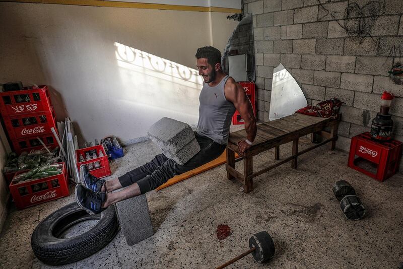 Palestinian bodybuilder Ahmed Tlatini, aged 26, trains at his home in Gaza City.  EPA