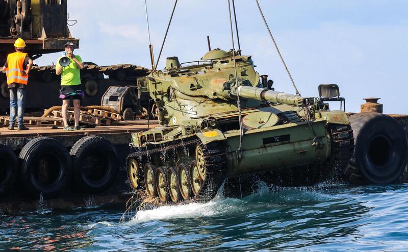 Environmental activists drop off old battle tanks provided by the Lebanese Armed Forces into the Mediterranean Sea to create a new reef.  All photos AFP Photo