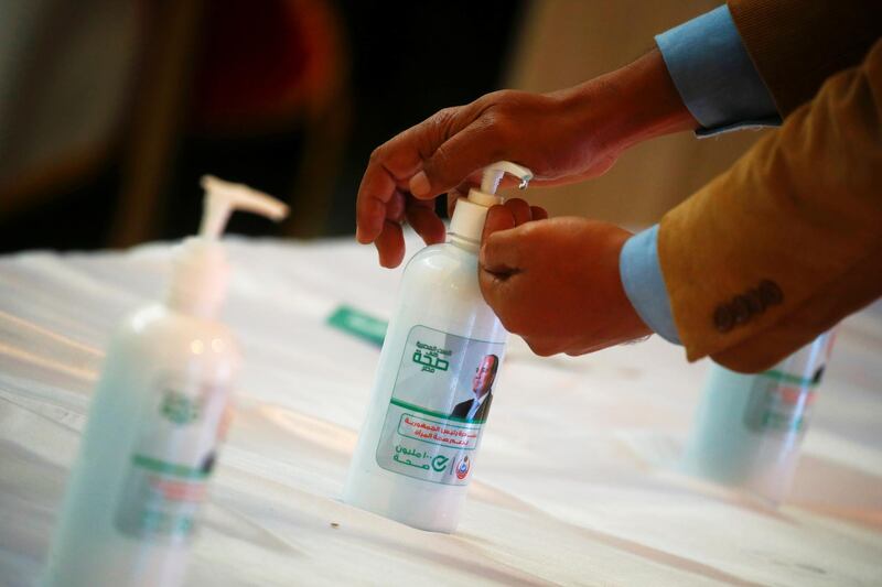 An image depicting Egyptian President Abdel Fatah al-Sisi is seen on a bottle of sanitiser before a news conference announcing the details of a vaccination campaign against the coronavirus disease (COVID-19) outbreak, in Cairo, Egypt December 23, 2020. REUTERS/Amr Abdallah Dalsh