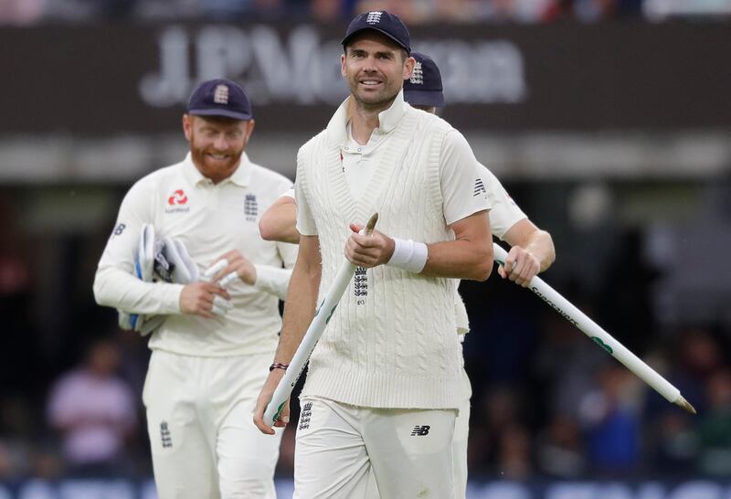 England's James Anderson leaves the pitch with his team mates after England bowl India out for 130 during the fourth day of the second test match between England and India at Lord's cricket ground in London, Sunday, Aug. 12, 2018. (AP Photo/Kirsty Wigglesworth)