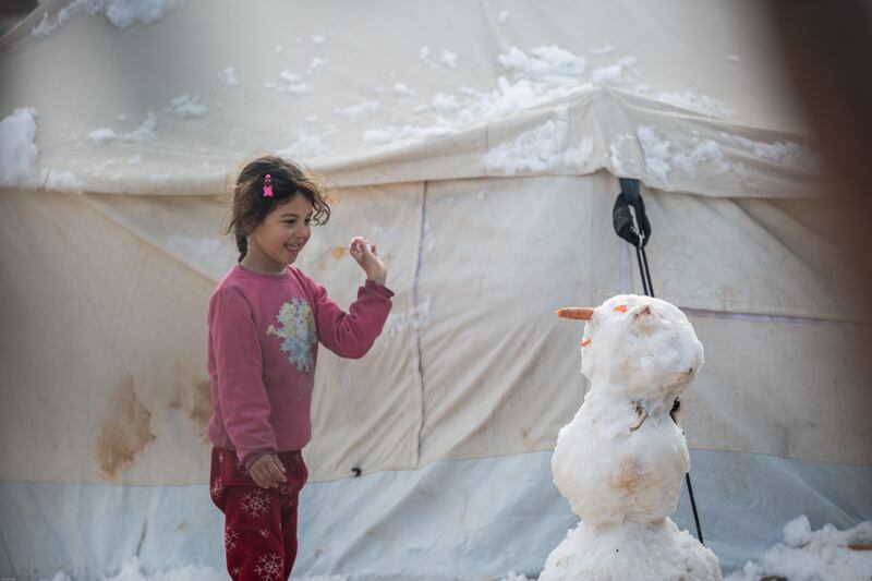 A child plays with a snowman at Al Zaytoun camp north of Aleppo.