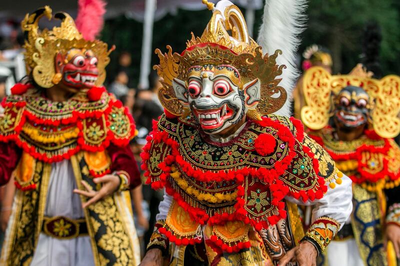 Balinese dancers take part in a parade to mark the opening of the annual Bali Art Festival on a main road in Denpasar, Bali, Indonesia. Made Nagi / EPA