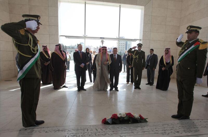 Saudi Prince Al Waleed Bin Talal visits the grave of former Palestinian leader Yasser Arafat during an official visit to the West Bank city of Ramallah on March 4, 2014. The billionaire is in the Israeli-occupied West Bank for a meeting with Palestinian president Mahmud Abbas. Abbas Momani / AFP photo