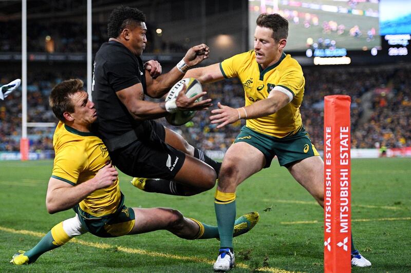 epa06956038 Waisake Naholo (C) of the All Blacks is tackled by Dane Haylett-Petty (L) and Bernard Foley (R) of the Wallabies during the first Bledisloe Cup rugby match between Australia and New Zealand at ANZ Stadium in Sydney, Australia, 18 August 2018.  EPA/DAN HIMBRECHTS AUSTRALIA AND NEW ZEALAND OUT