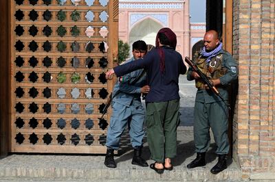 An Afghan security personnel frisks a man at the entrance of a mosque during Eid Al Adha prayers in Kabul. AFP