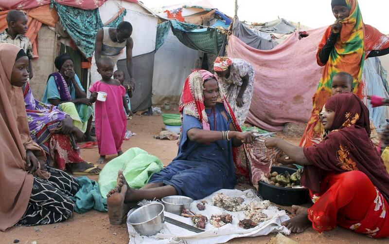 Women displaced from the capital Mogadishu chop meat to sell to customers in the once-bustling pirate town of Galkayo, Somalia. Farah Abdi Warsameh / AP
