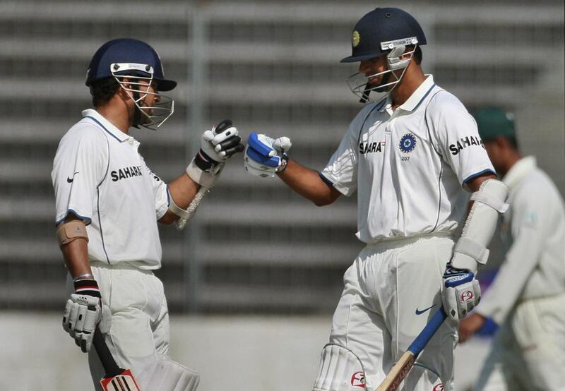 The India batting legends Sachin Tendulkar, left, and Rahul Dravid have 91,659 runs between them across all three formats. Pavel Rahman / AP Photo

