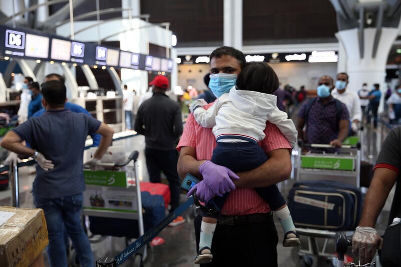 Indian nationals check in at the Muscat International Airport before leaving the Omani capital on a flight to return to their country.  AFP