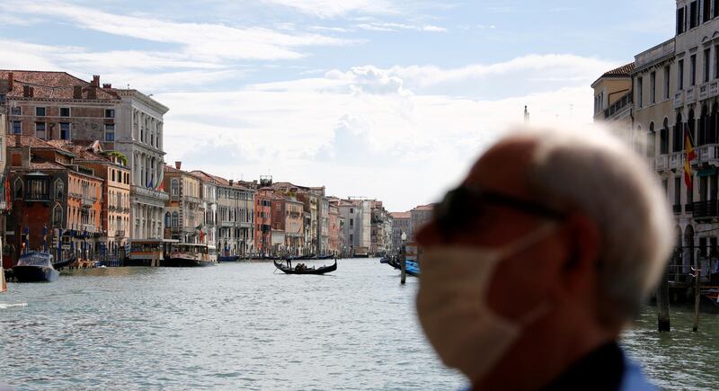 A man wears a face mask on board of a vaporetto at Grand Canal, amid the coronavirus outbreak, in Venice, Italy. Reuters