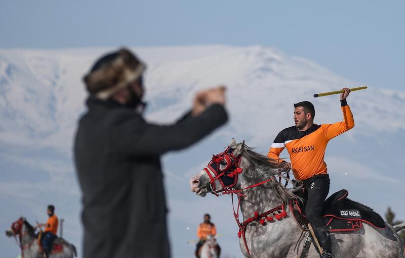 A player prepares to launch a javelin at an opponent during a game of jereed in Erzurum, Turkey. It is against the rules to hit a horse, and results in the offender being sent off. EPA