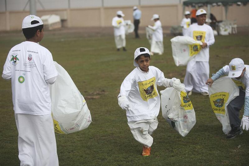 Young volunteers help to keep Abu Dhabi green and clean by removing rubbish from the Emirates Heritage Club in Al Samha yesterday as part of the annual Clean Up UAE campaign. Similar efforts were also taking place at Mussaffah, Al Bateen, Zafranah and Al Wathba. Lee Hoagland / The National