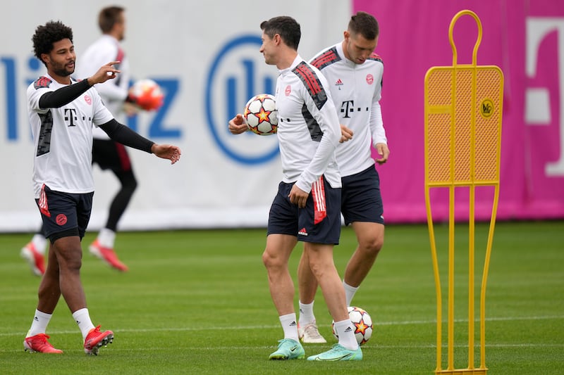 Bayern's Serge Gnabry, left, and Robert Lewandowski joke during a training session. AP Photo