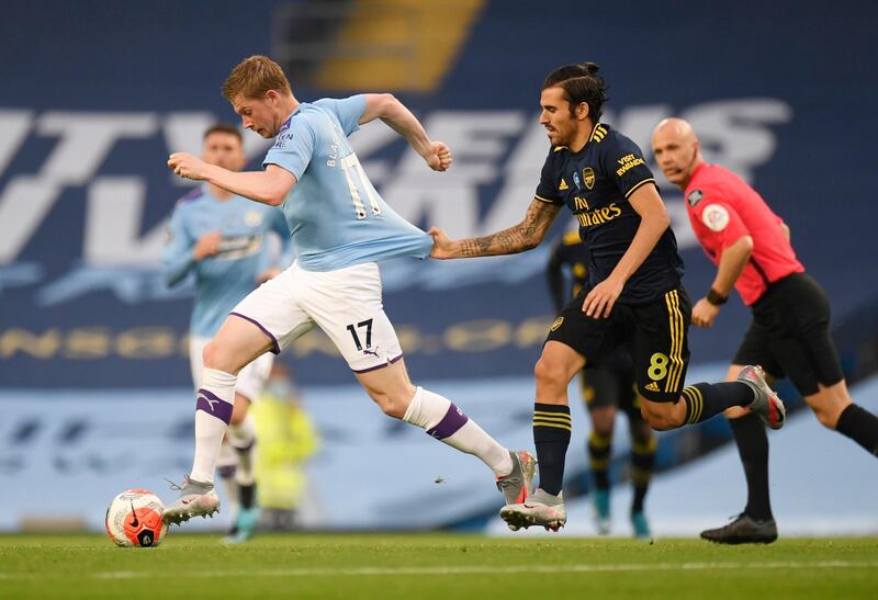 Manchester City's Kevin De Bruyne has his shirt pulled by Dani Ceballos of Arsenal during the match at the Etihad Stadium on Wednesday, June 17. City won the game 3-0. Reuters