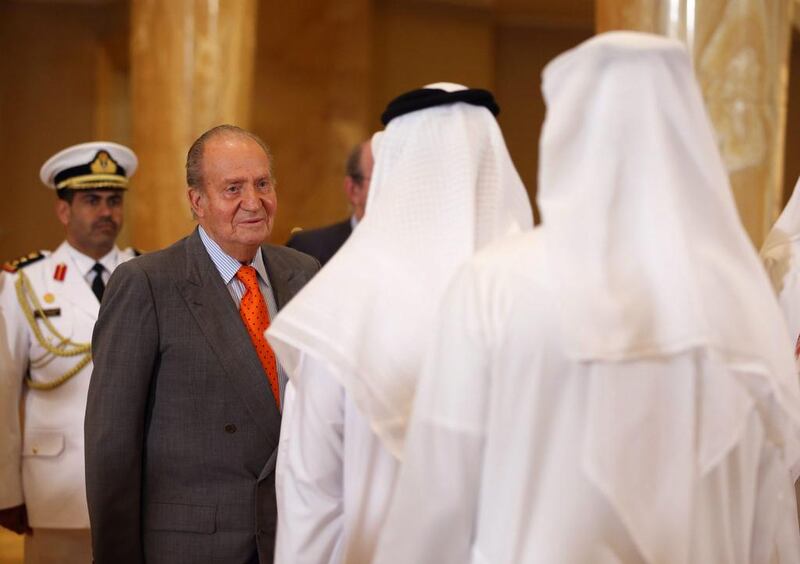 King Juan Carlos, second from left, welcomed by UAE officials at the Emirates Palace hotel. Ali Haider / EPA