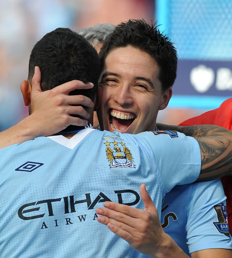 Manchester City's Samir Nasri celebrates winning the 2012 Premier League title with Carlos Tevez. AFP