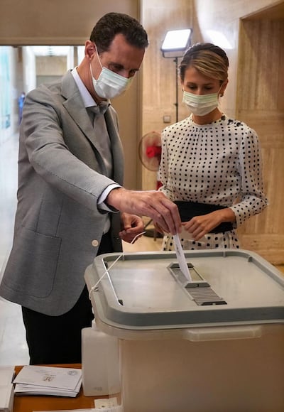 (FILES) In this file handout picture released by the Syrian Presidency Facebook page on July 19, 2020, shows Syrian President Bashar al-Assad and his wife Asma voting at a polling station in the capital Damascus, during the parliamentary elections. The Syrian president and his wife have tested positive for COVID-19 after experiencing mild symptoms, the presidency said on March 8, 2021. - RESTRICTED TO EDITORIAL USE - MANDATORY CREDIT "AFP PHOTO / Syrian Presidency Facebook page " - NO MARKETING NO ADVERTISING CAMPAIGNS - DISTRIBUTED AS A SERVICE TO CLIENTS
 / AFP / Syrian Presidency Facebook page / - / RESTRICTED TO EDITORIAL USE - MANDATORY CREDIT "AFP PHOTO / Syrian Presidency Facebook page " - NO MARKETING NO ADVERTISING CAMPAIGNS - DISTRIBUTED AS A SERVICE TO CLIENTS
