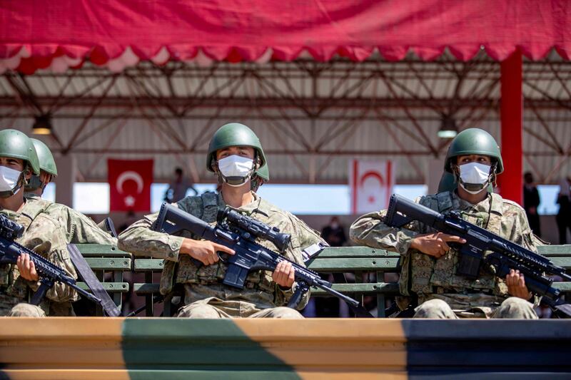 Mr Erdogan reviews a guard of honour with the Turkish Cypriot leader.  Reuters