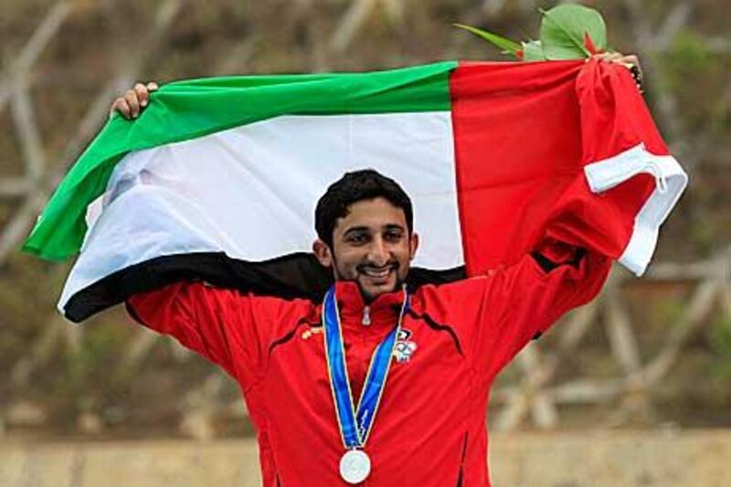 Sheikh Juma bin Dalmouk Al Maktoum celebrates after winning silver in the double trap at the Asian Games in Guangzhou.