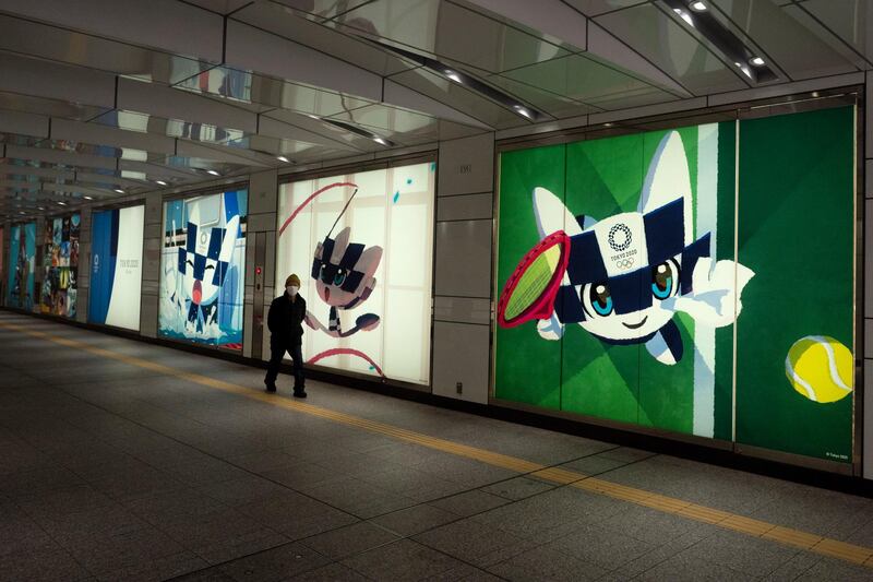 A man walks past large displays promoting the Tokyo 2020 Olympics in Tokyo on Monday. AP