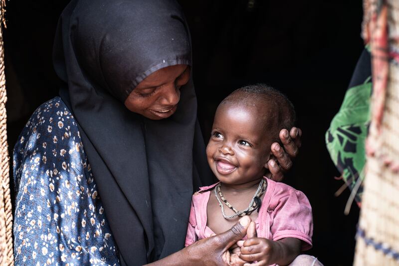 Mahadha Ibrahim Abdi, a 30-year-old mother on Kenya, hugs her baby Fatuma who suffers from malnutrition.