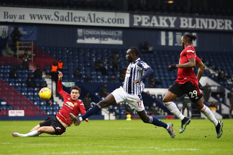 West Bromwich Albion's Senegalese striker Mbaye Diagne (C) misses a chance during the English Premier League football match between West Bromwich Albion and Manchester United at The Hawthorns stadium in West Bromwich, central England, on February 14, 2021.  - RESTRICTED TO EDITORIAL USE. No use with unauthorized audio, video, data, fixture lists, club/league logos or 'live' services. Online in-match use limited to 120 images. An additional 40 images may be used in extra time. No video emulation. Social media in-match use limited to 120 images. An additional 40 images may be used in extra time. No use in betting publications, games or single club/league/player publications.
 / AFP / POOL / Michael Steele / RESTRICTED TO EDITORIAL USE. No use with unauthorized audio, video, data, fixture lists, club/league logos or 'live' services. Online in-match use limited to 120 images. An additional 40 images may be used in extra time. No video emulation. Social media in-match use limited to 120 images. An additional 40 images may be used in extra time. No use in betting publications, games or single club/league/player publications.
