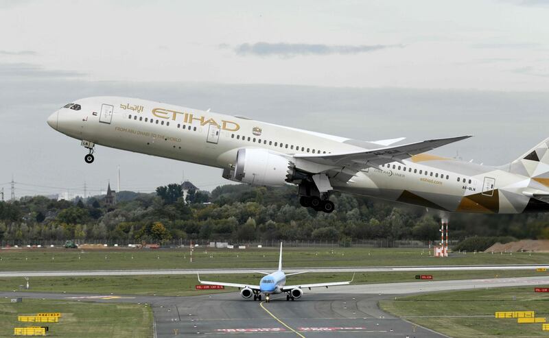 (FILES) In this file photo taken on September 24, 2019 a Boeing 787-10 Dreamliner of the Etihad airline during take-off at the airport in Duesseldorf, western Germany. As coronavirus grounds airlines, plunging the industry into unprecedented crisis, Middle East carriers that have been in the red for years must urgently tap assistance from governments facing their own revenue slump. Authorities across the region have taken draconian measures to curb the disease, closing airports and halting passenger flights, and bringing major hubs like Dubai and Abu Dhabi to a standstill. / AFP / Ina FASSBENDER
