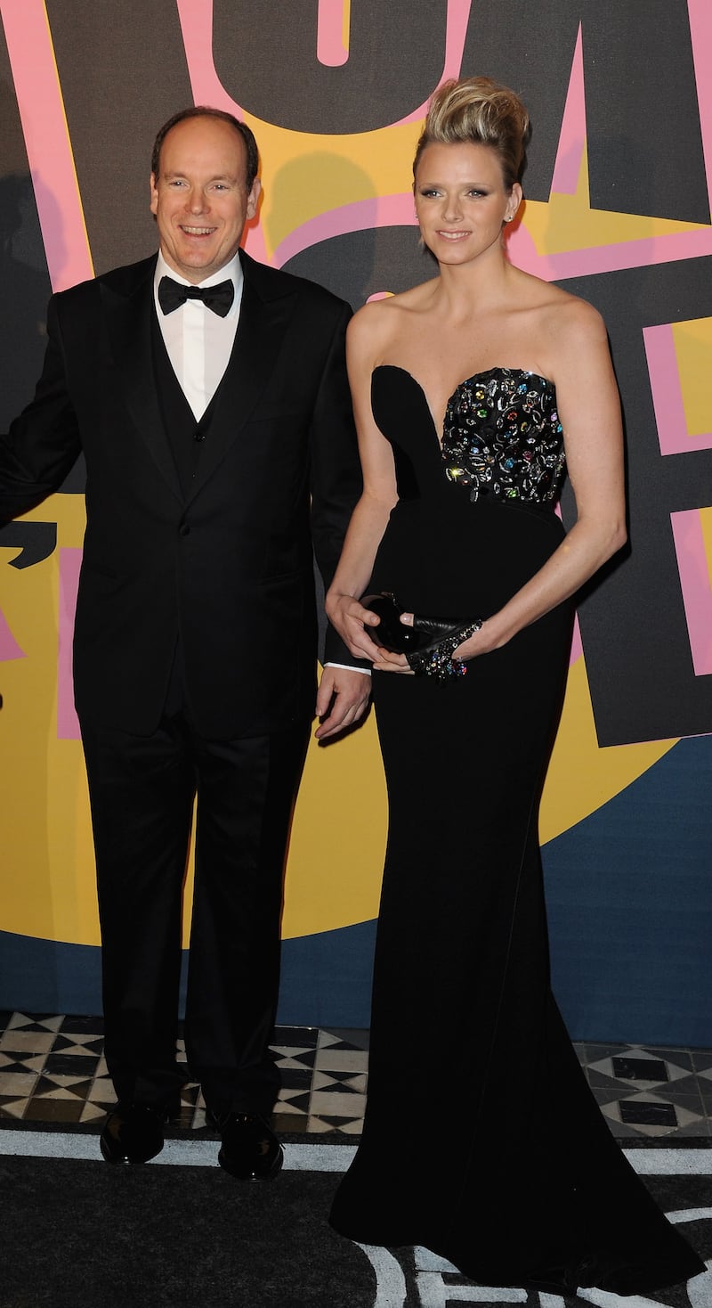 Prince Albert II of Monaco and Charlene Wittstock, in a black dress with sequin detailing, arrive at the 2009 Monte Carlo Rock' N Rose Ball on March 28, 2009. Getty Images