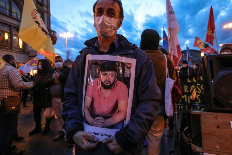 The father of victim Ferhat Unvar holds a portrait of his son as he takes part in a rally to commemorate the victims of the 2020 Hanau shooting in Frankfurt. AFP