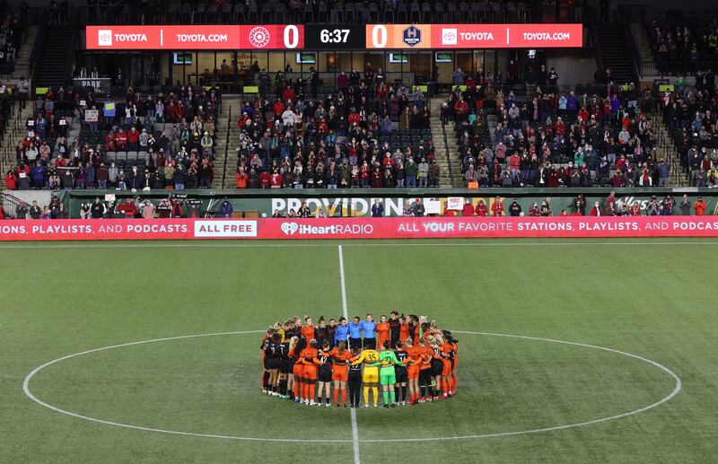 Portland Thorns and Houston Dash players, along with referees, gather in the centre circle in demonstration of solidarity with two former NWSL players who came forward with allegations of sexual harassment and misconduct against a prominent coach. AP Photo