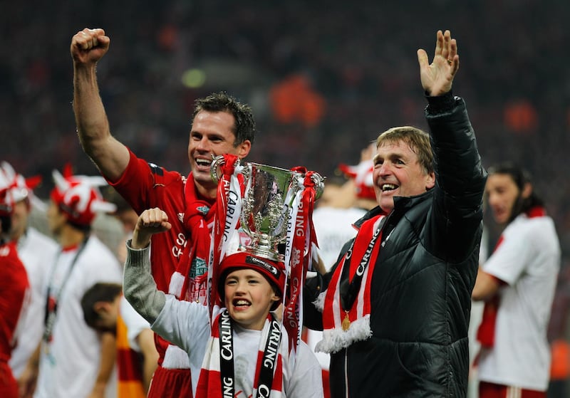 LONDON, ENGLAND - FEBRUARY 26:  Kenny Dalglish manager of Liverpool and Jamie Carragher celebrate with the trophy  after the Carling Cup Final match between Liverpool and Cardiff City at Wembley Stadium on February 26, 2012 in London, England. Liverpool won 3-2 on penalties.  (Photo by Paul Gilham/Getty Images)