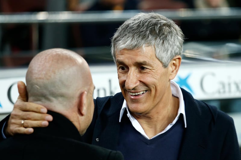 Barcelona manager Quique Setien, right, greets Levante counterpart  Paco Lopez. AP