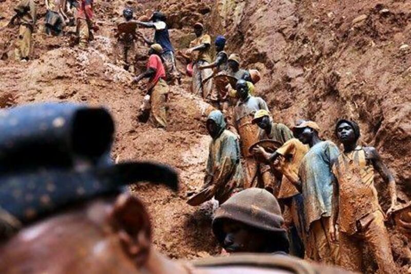 Men work in a gold mine in Chudja, near Bunia, north eastern Congo, one of the conflict areas watchdogs want to stop illicit trading from. AFP PHOTO / LIONEL HEALING