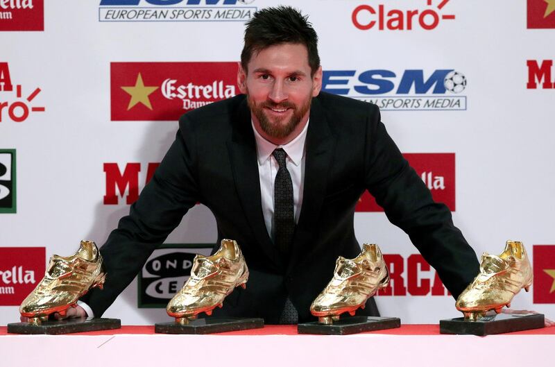 Barcelona's Lionel Messi poses with his four Golden Boot trophies during a ceremony in Barcelona, Spain, November 24, 2017.  REUTERS/Albert Gea     TPX IMAGES OF THE DAY