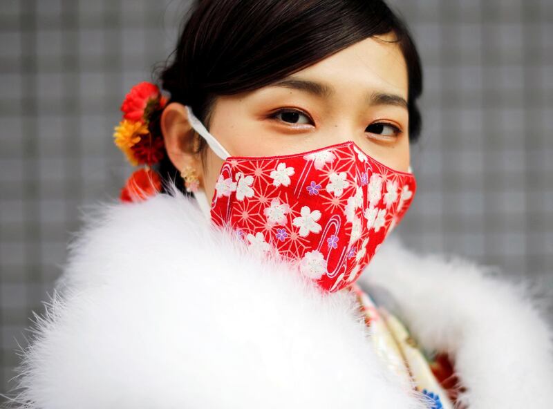 A Kimono-clad woman wearing a fashionable face mask poses for a photograph at Coming of Age Day celebration ceremony at Yokohama Arena after the government declared the second state of emergency for the capital and some prefectures, amid the coronavirus disease (COVID-19) outbreak, in Yokohama, south of Tokyo, Japan January 11, 2021. REUTERS/Issei Kato