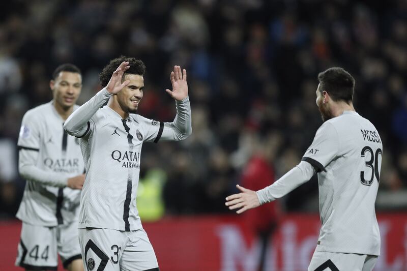 Paris Saint Germain teenager Warren Zaire-Emery , centre, celebrates with teammate Lionel Messi after scoring the third goal. EPA