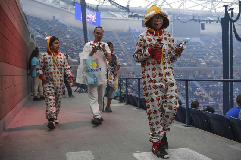 Fans dressed in costume attend day one of the Fortnite World Cup Finals at Arthur Ashe Stadium in the Queens borough of New York City. AFP