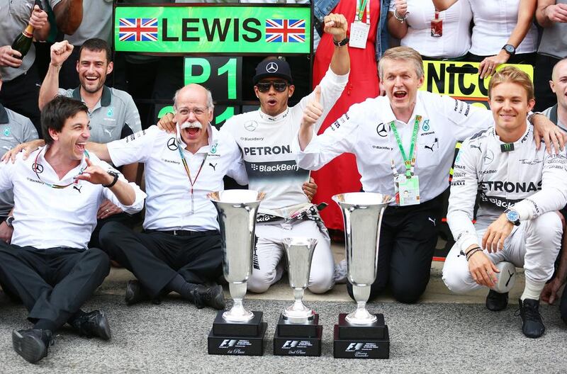 Lewis Hamilton, centre, of Mercedes GP celebrates his victory with teammate Nico Rosberg, right, Mercedes GP executive director Toto Wolff, left, and the rest of the team after the Spanish Formula One Grand Prix at Circuit de Catalunya on May 11, 2014 in Montmelo, Spain. Mark Thompson/Getty Images
