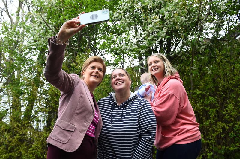 Scotland's First Minister and Scottish National Party (SNP) leader Nicola Sturgeon poses with voters after casting her vote in Glasgow. AFP